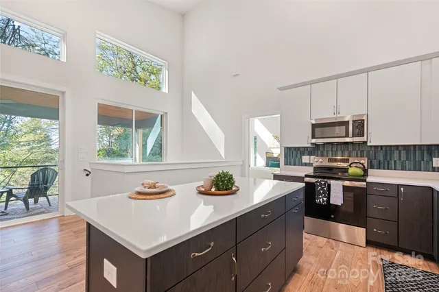 a kitchen with a stove a sink and a microwave