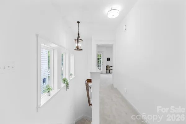 a hallway with a white stove next to a window