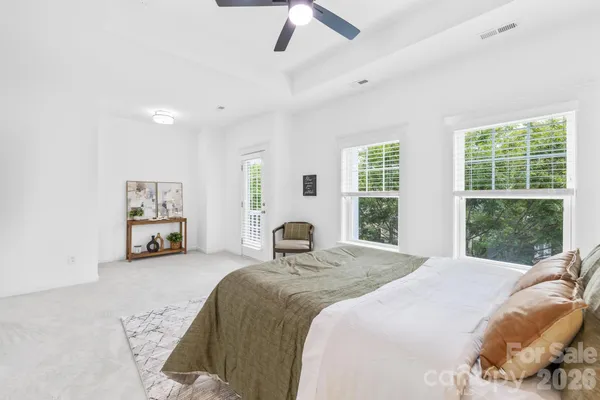 a bedroom with a bed and a large window