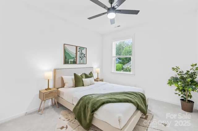 a bed sitting in a bedroom next to a window