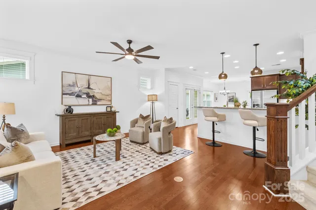 a living room with furniture and kitchen view