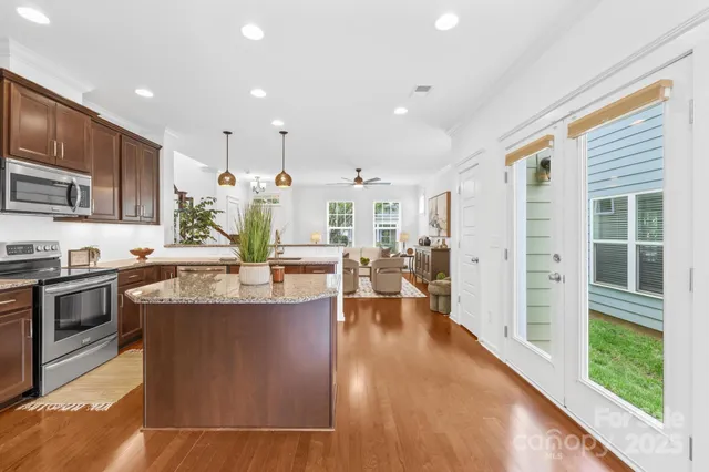 a large kitchen with stainless steel appliances and a large window