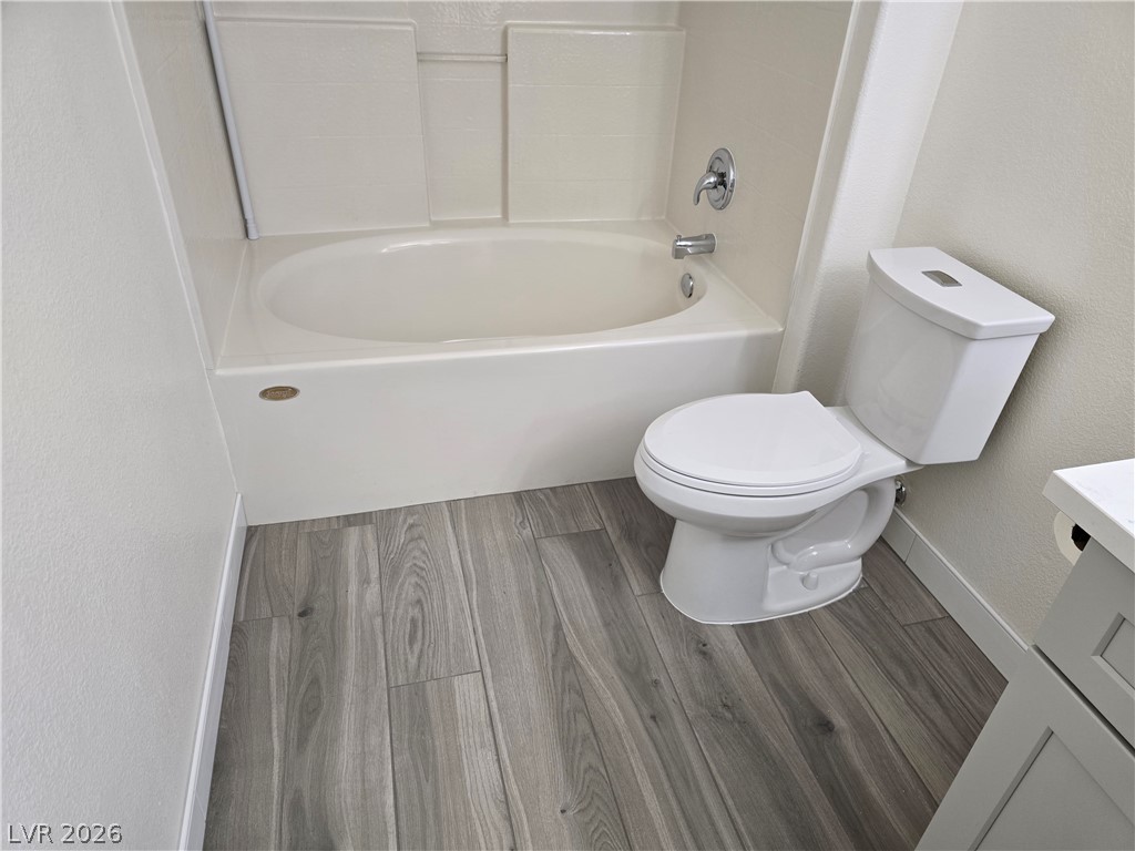 1881 West Alexander Road, Unit 1127 North Las Vegas, NV 89032 - Photo 13 of 20 Newly installed wood-look flooring enhances this pristine bathroom's modern appeal.