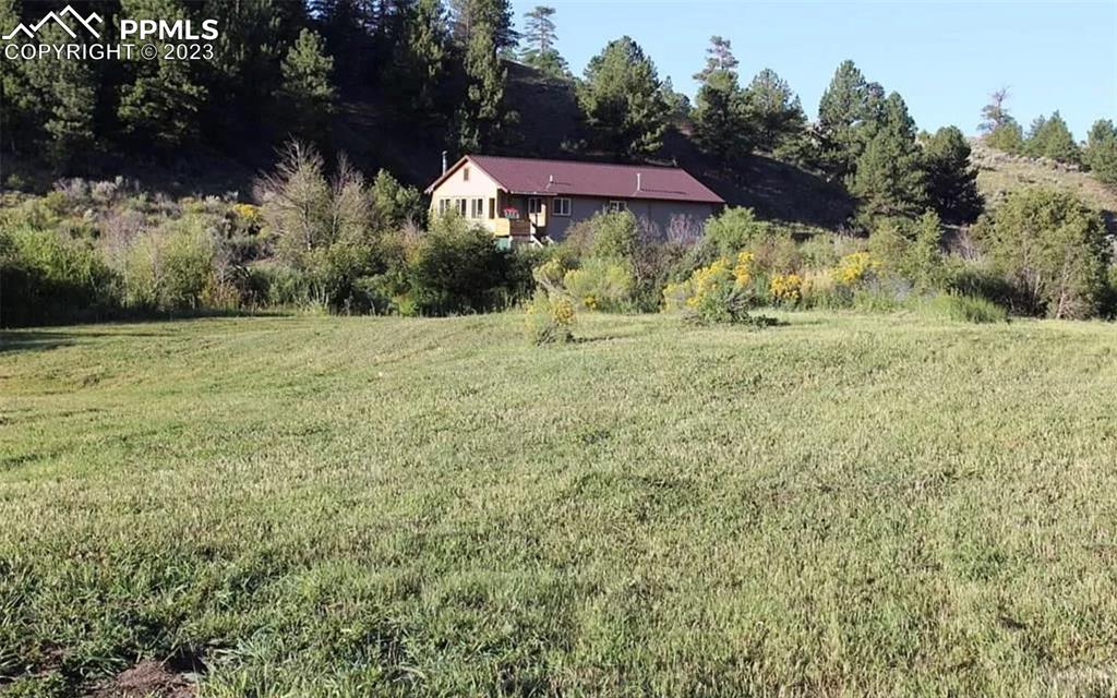 7618 Beekman Road Fort Garland, CO 81133 - Photo 5 of 8 a view of a yard with an outdoor space