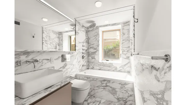 a view of a livingroom with workspace and a window