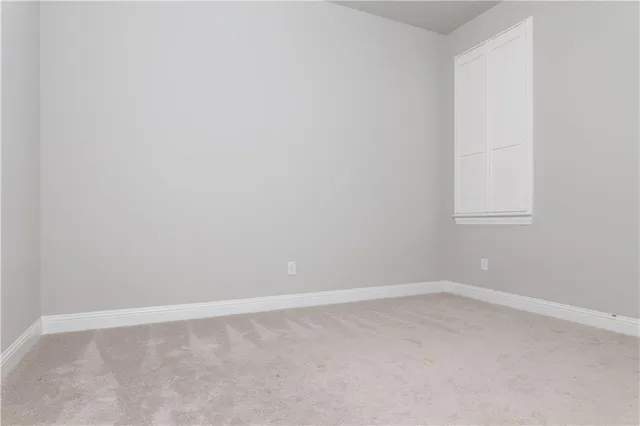 an empty room with closet area