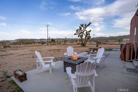 a living room with furniture a flat screen tv and a large window