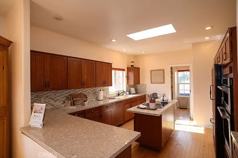 a living room with furniture a ceiling fan and a window