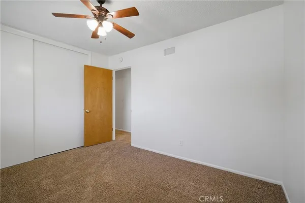 an empty room with a ceiling fan and a ceiling fan