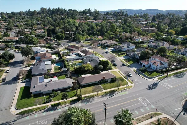 an aerial view of multiple houses with a yard