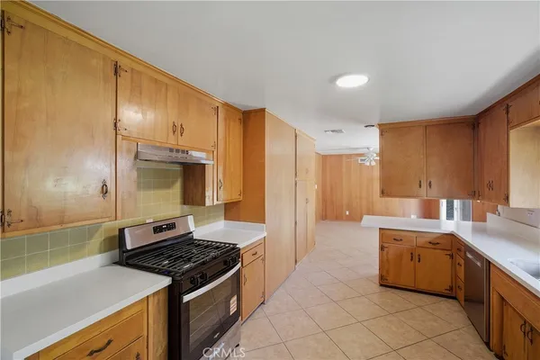 a kitchen with a stove sink and cabinets