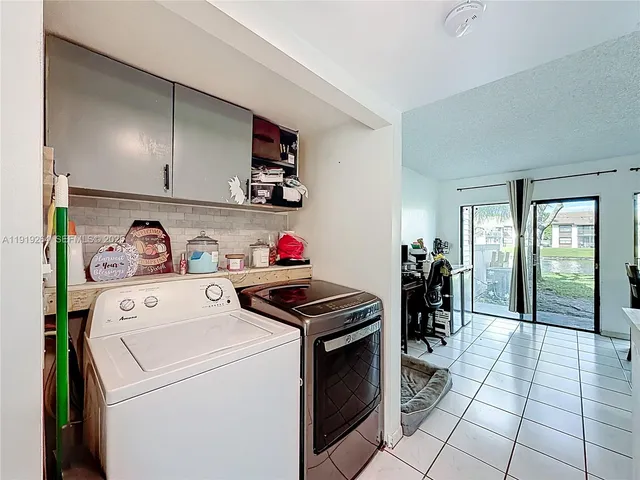 a view of a hallway with wooden floor and a bathroom