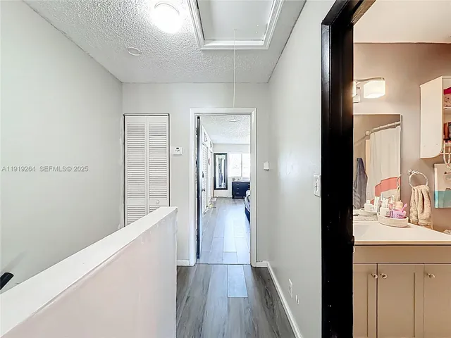 a bedroom with bed and a chandelier