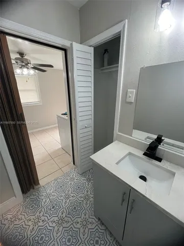 a bathroom with a sink a mirror and shower