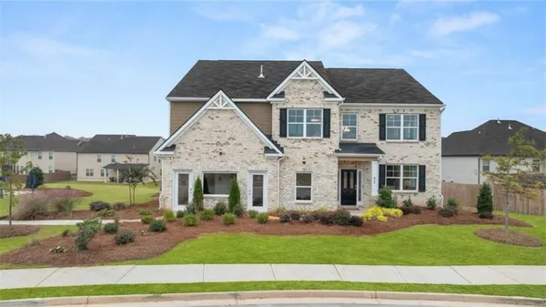 a front view of a house with a yard
