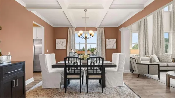a view of a dining room with furniture and chandelier