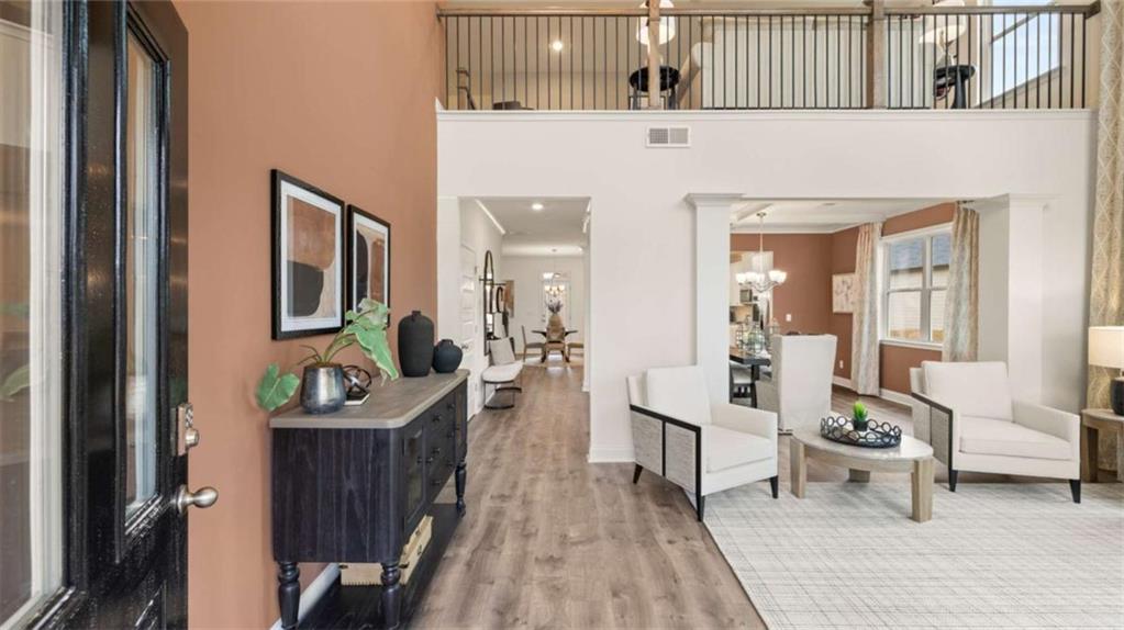 687 Edgar Street Hampton, GA 30228 - Photo 8 of 79 a living room with furniture and a wooden floor
