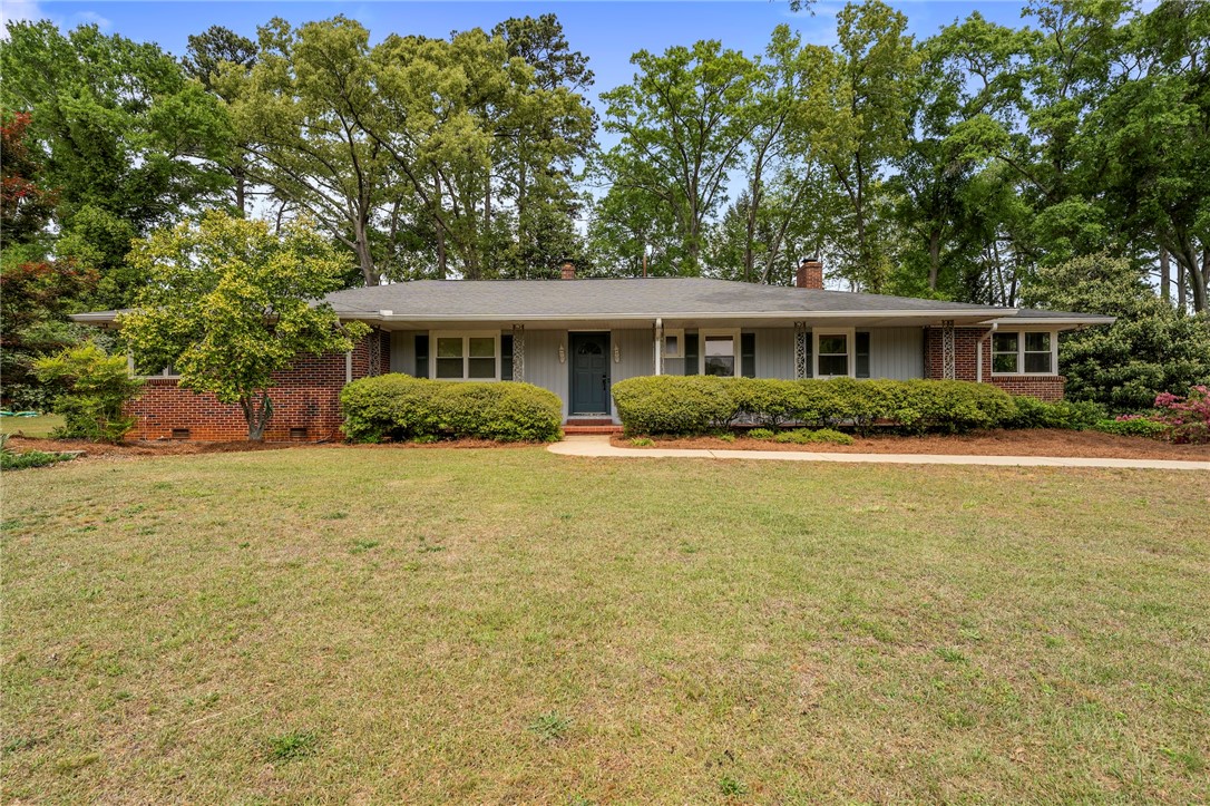 1105 Greenacres Anderson, SC 29621 - Photo 1 of 46 A classic ranch-style home featuring brick and siding, nestled among mature trees and lush landscaping.