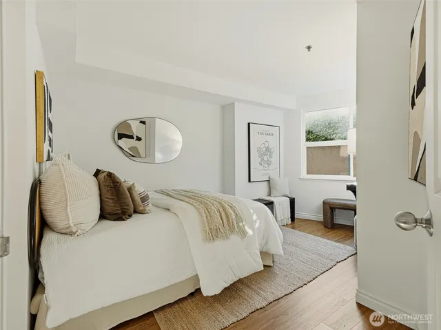 a bedroom with a bed and a painting on the wall