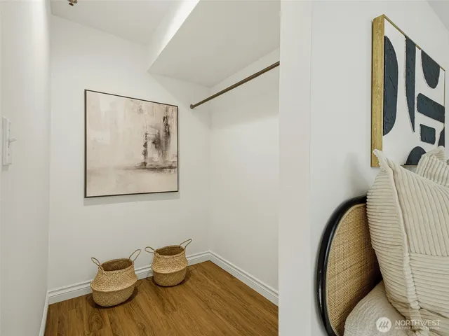 a bedroom with a large bed and painting on the wall