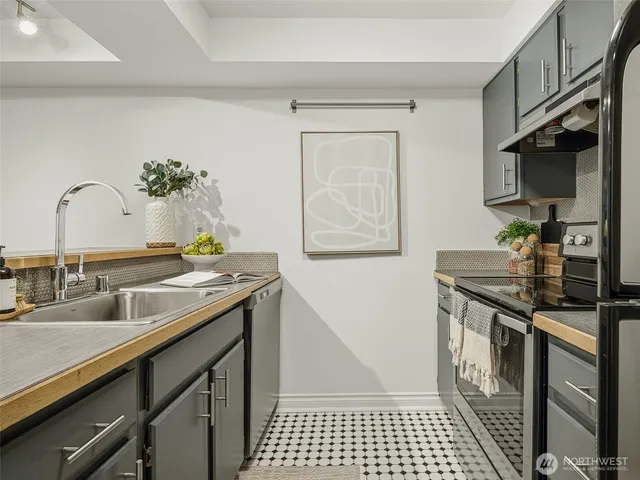 a kitchen with stainless steel appliances granite countertop a refrigerator and a sink