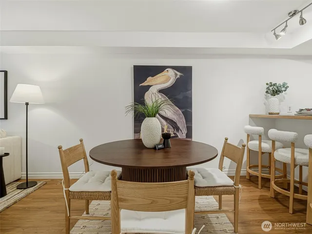 a dining room with furniture and wooden floor