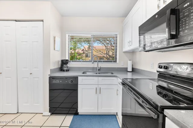 a kitchen with a sink stove and cabinets