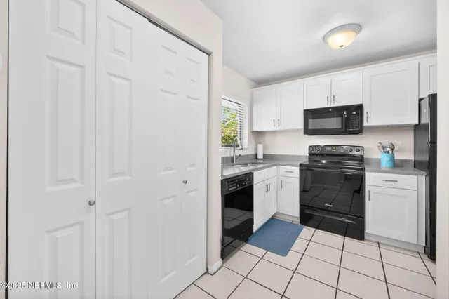 a kitchen with a stove a sink and a microwave