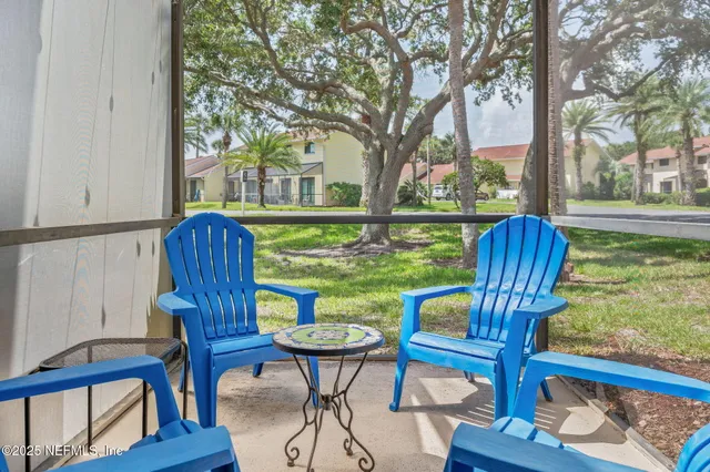 a view of a two chairs in the deck next to a yard