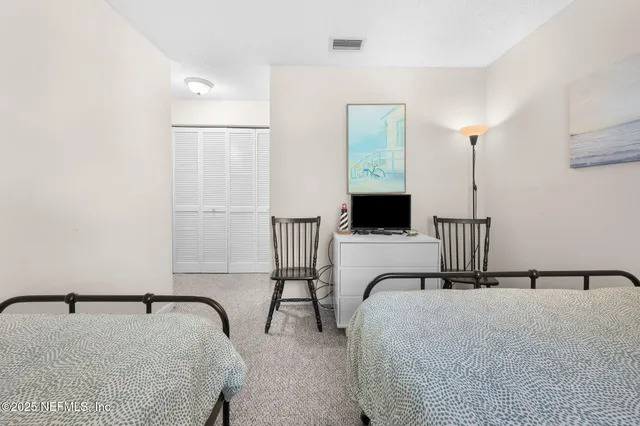 a view of a hallway with bathroom and entryway