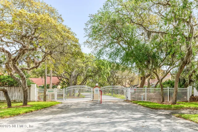 a view of a house with a tree in the yard