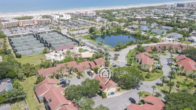 an aerial view of multiple houses with yard