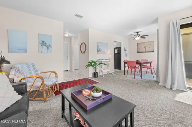 a living room with furniture and next to a window
