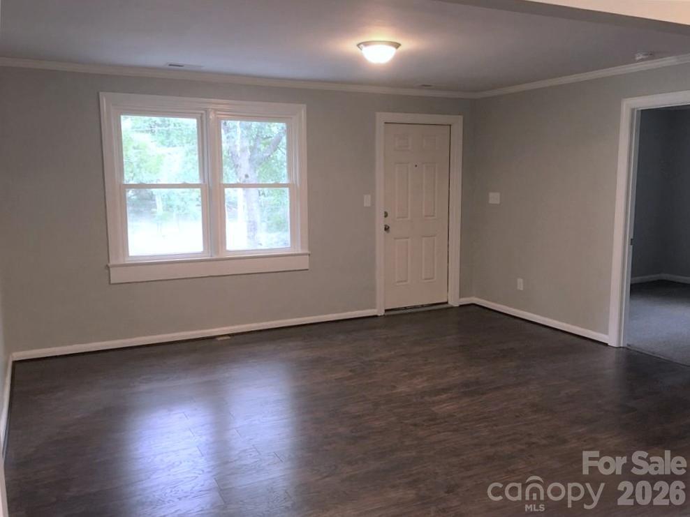 201 Bethlehem Church Road Grover, NC 28073 - Photo 2 of 4 an empty room with wooden floor and windows