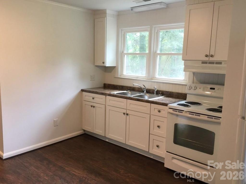 201 Bethlehem Church Road Grover, NC 28073 - Photo 3 of 4 a kitchen with granite countertop white cabinets and white appliances
