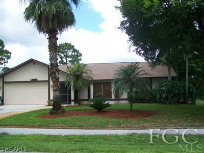 8329 Trillium Road Fort Myers, FL 33967 - Photo 1 of 10 a front view of a house with a garden
