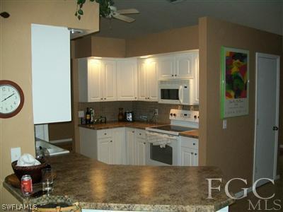8329 Trillium Road Fort Myers, FL 33967 - Photo 3 of 10 a kitchen with a sink and a stove top oven