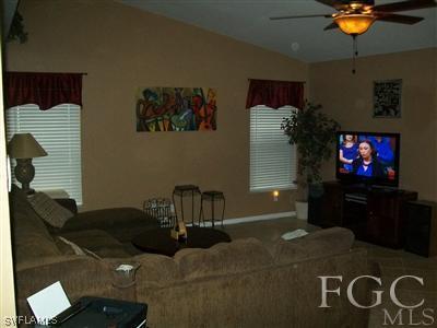 8329 Trillium Road Fort Myers, FL 33967 - Photo 4 of 10 a living room with furniture and a flat screen tv