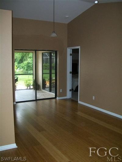 8329 Trillium Road Fort Myers, FL 33967 - Photo 6 of 10 an empty room with wooden floor and windows