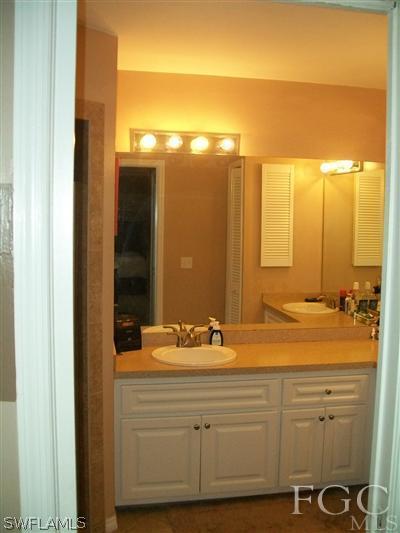 8329 Trillium Road Fort Myers, FL 33967 - Photo 9 of 10 a bathroom with a sink and a mirror