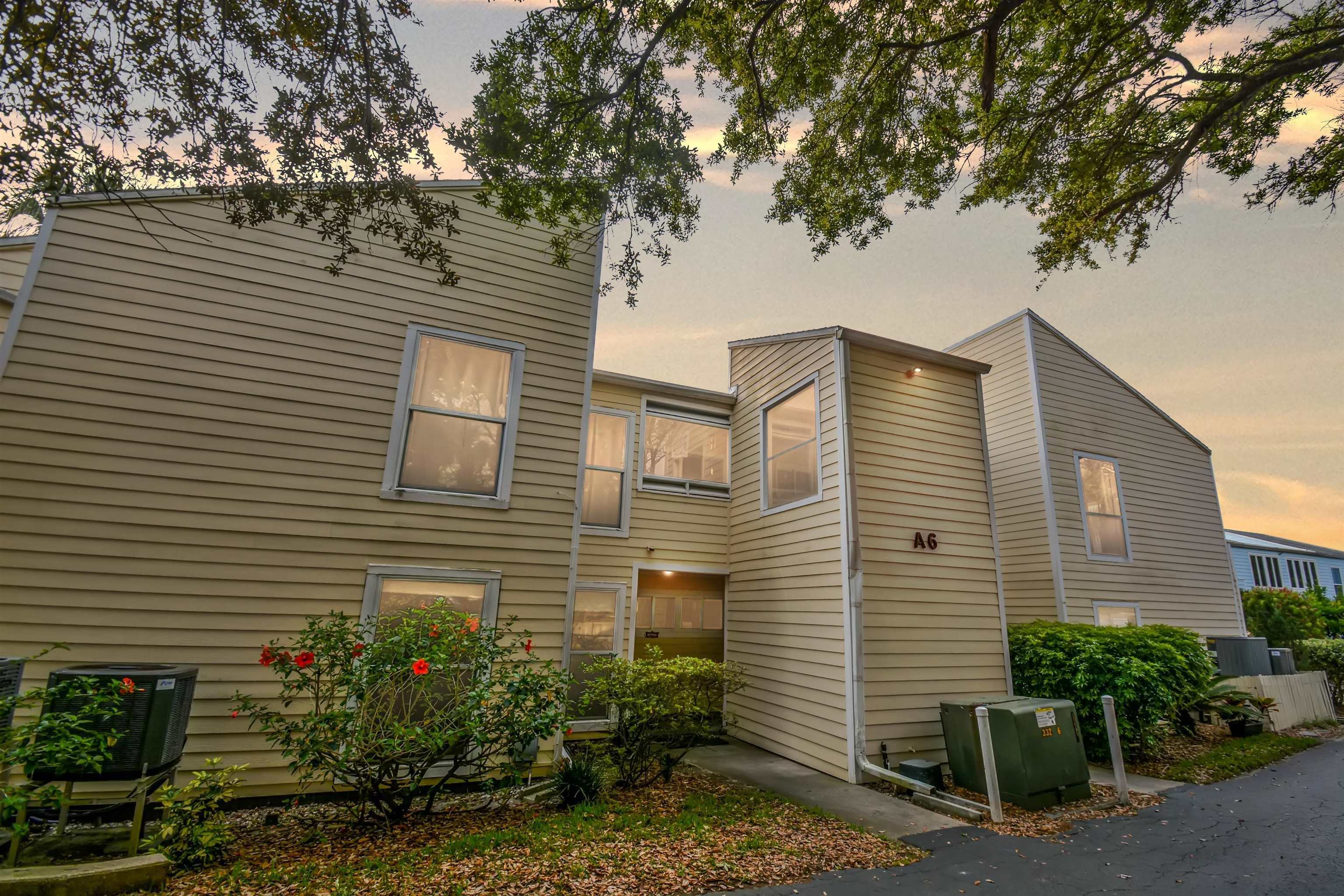 a view of a house with a yard and plants