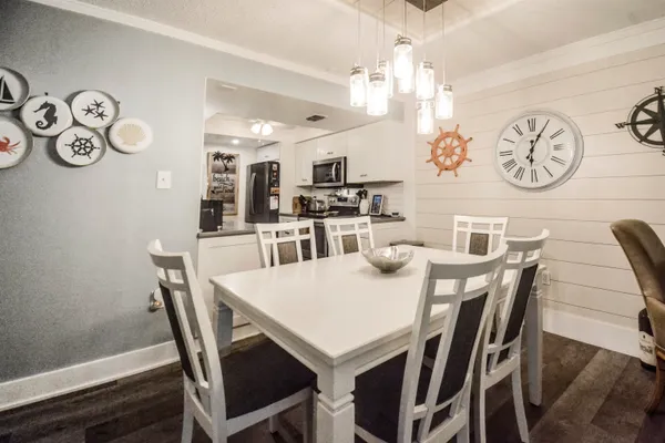 a view of a dining room with furniture and wooden floor