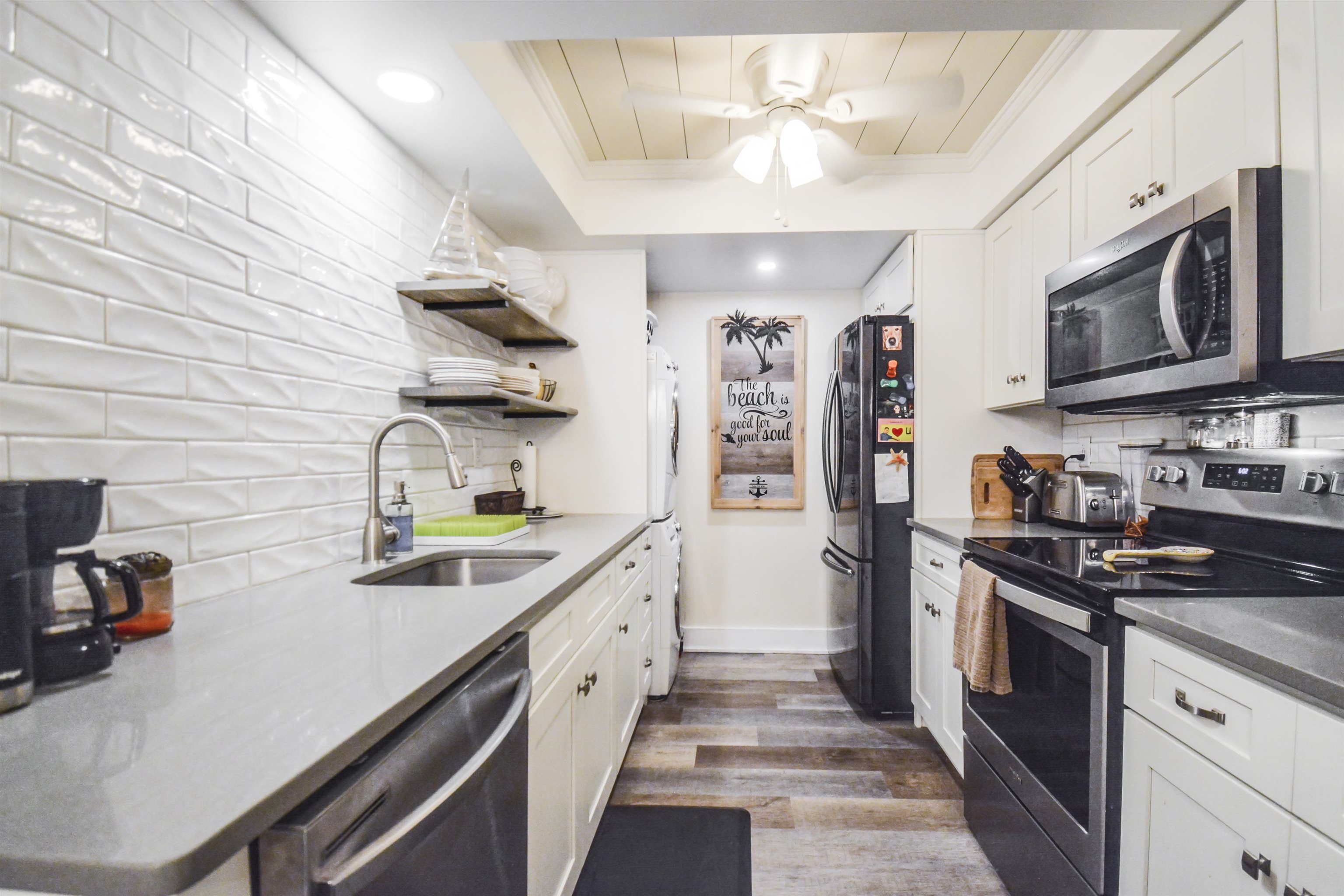 6300 A1A South St. Augustine, FL 32080 - Photo 12 of 42 a kitchen with stainless steel appliances granite countertop a sink stove and refrigerator