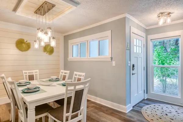 a dining room with a table and chairs