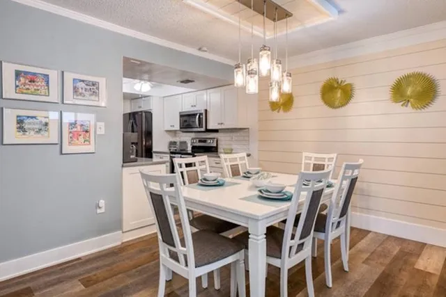 a view of a dining room with furniture and wooden floor