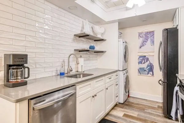 a kitchen with stainless steel appliances a sink and cabinets