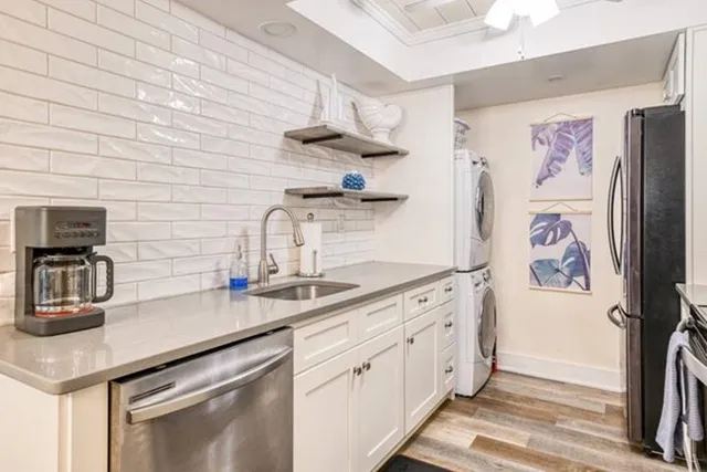 a kitchen with stainless steel appliances a sink and cabinets