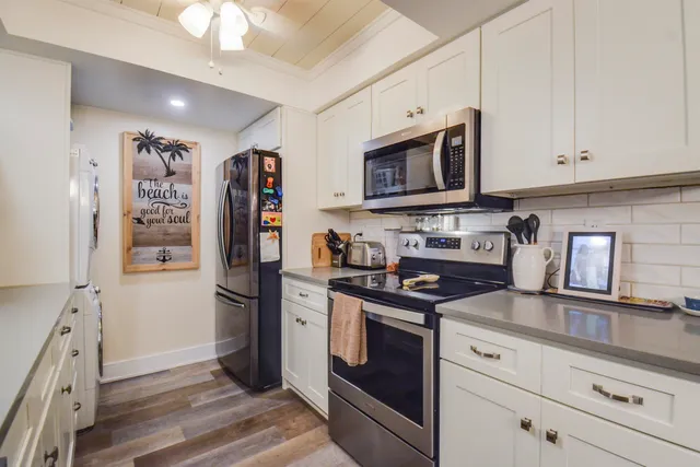 a kitchen with stainless steel appliances granite countertop a stove microwave and refrigerator