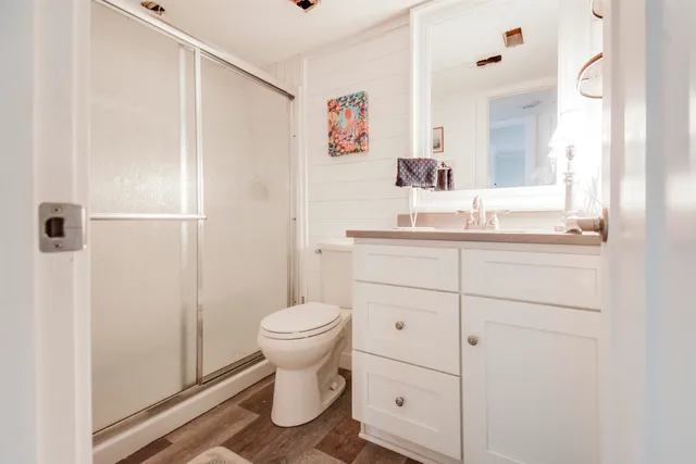 a bathroom with a sink a toilet and shower