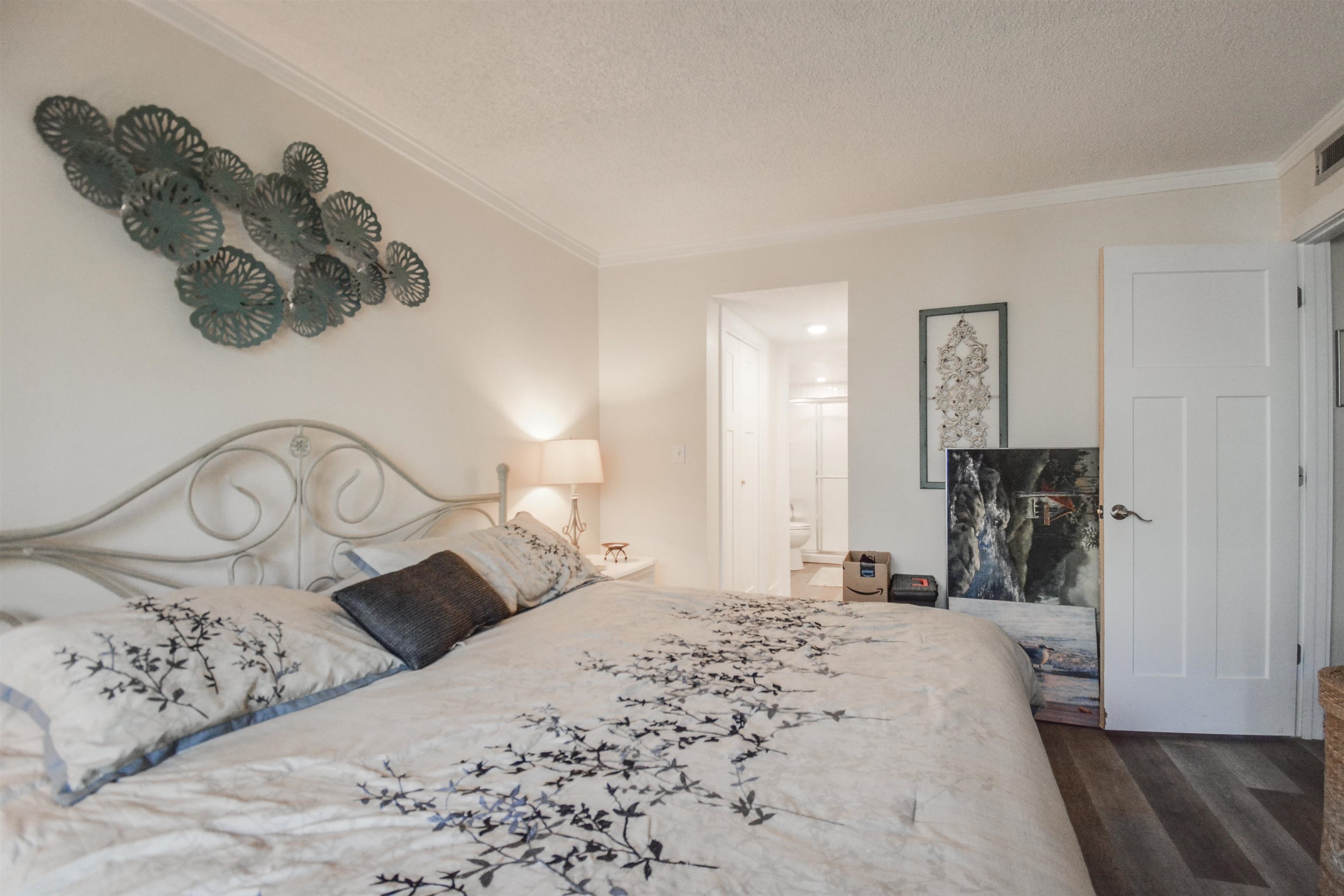 6300 A1A South St. Augustine, FL 32080 - Photo 28 of 42 a bedroom with a bed and a chandelier